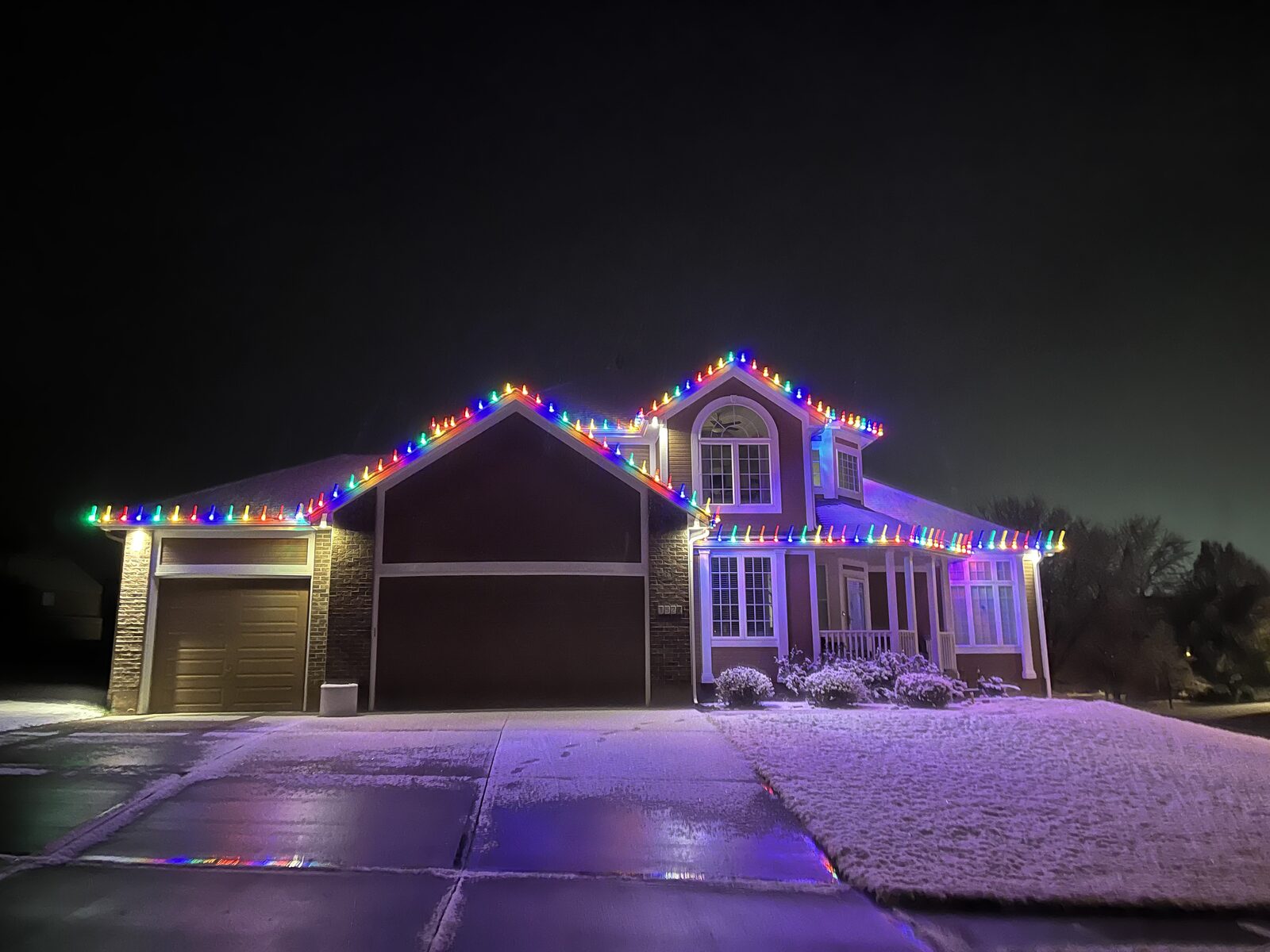 C9 LED Christmas lights on residential roofline — professional installation
