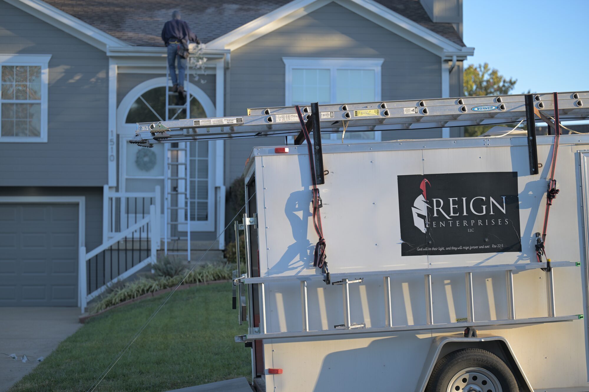 Reign Enterprises branded work trailer on-site during Christmas light installation